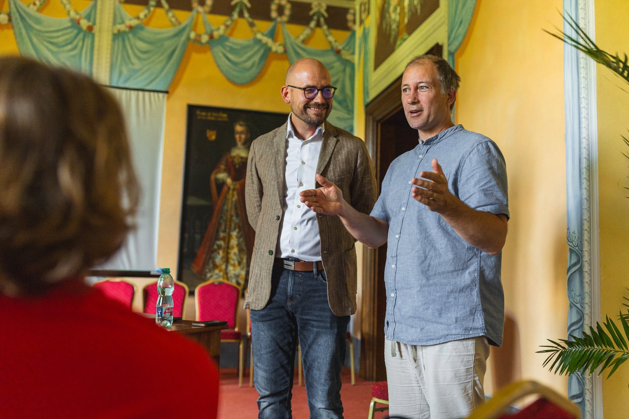 Artur Malke and a colleague speaking during a workshop